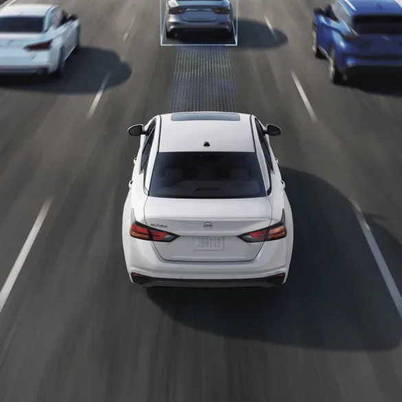 2027 Nissan Altima on freeway surrounded by cars with schematic drawings of ProPILOT Assist capabilities at Dublin Nissan in Dublin GA