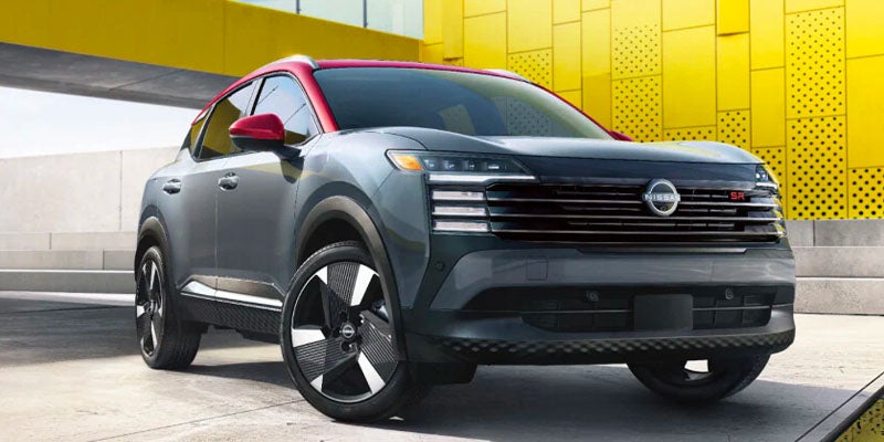 2025 Nissan Kicks parked next to a building